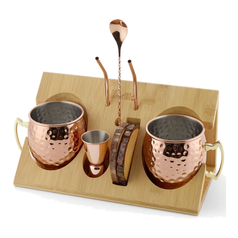 Copper Moscow Mule mugs and tools displayed on a bamboo stand